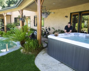Woman relaxing in an outdoor hot tub 