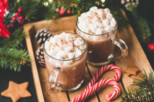 Peppermint hot chocolate served on a wooden tray.