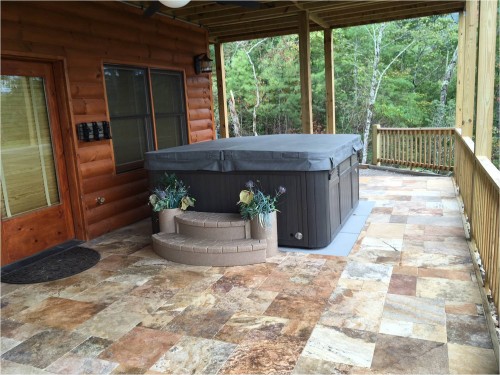 Outdoor hot tub with a cover on it.