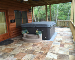 Outdoor hot tub with a cover on it.